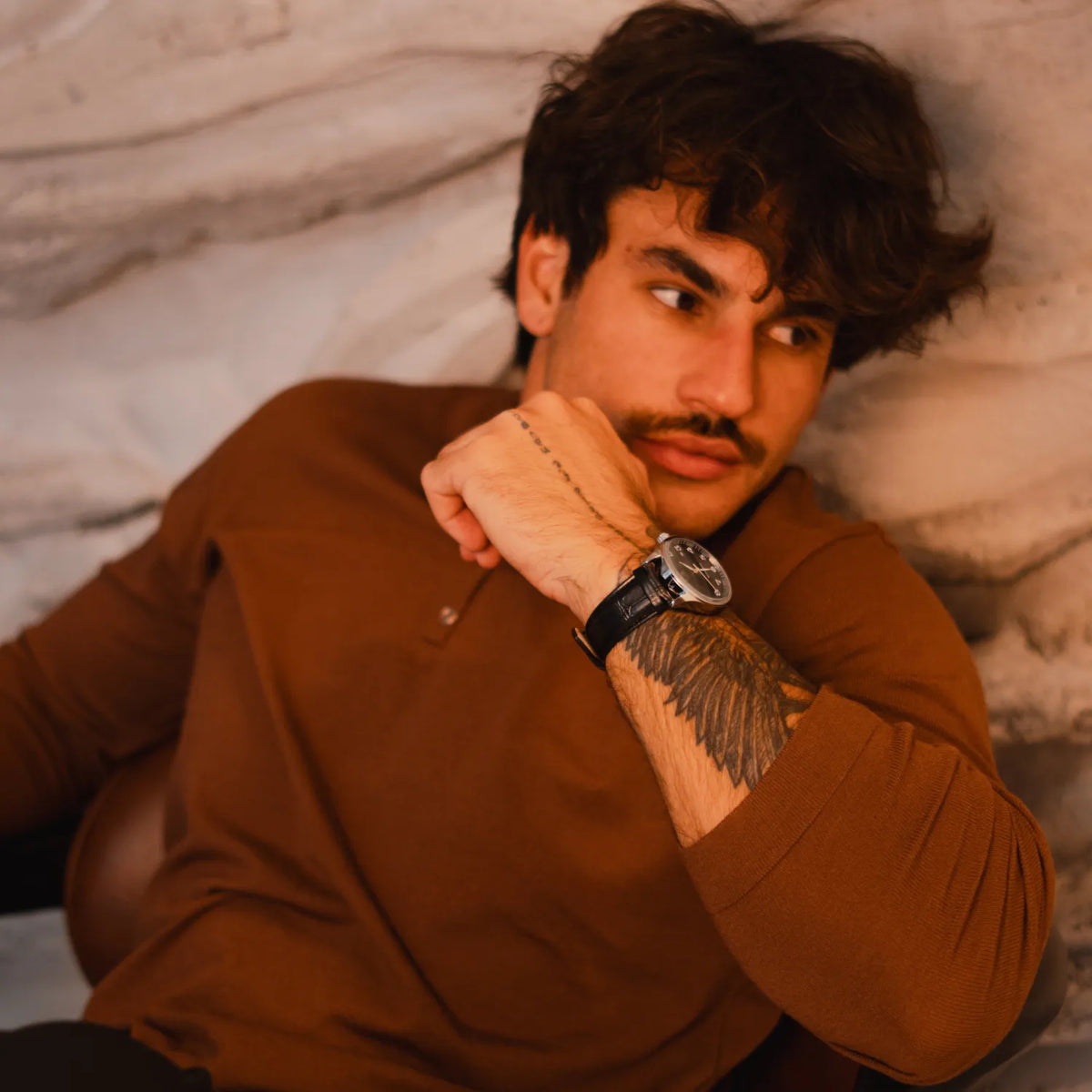 DALMONT Winner automatic watch worn with a brown sweater, arm folded