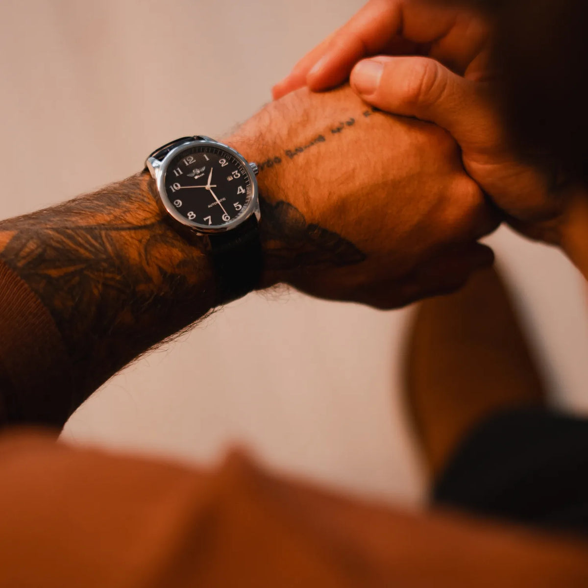 DALMONT Winner black dial automatic watch on a tattooed wrist, close-up
