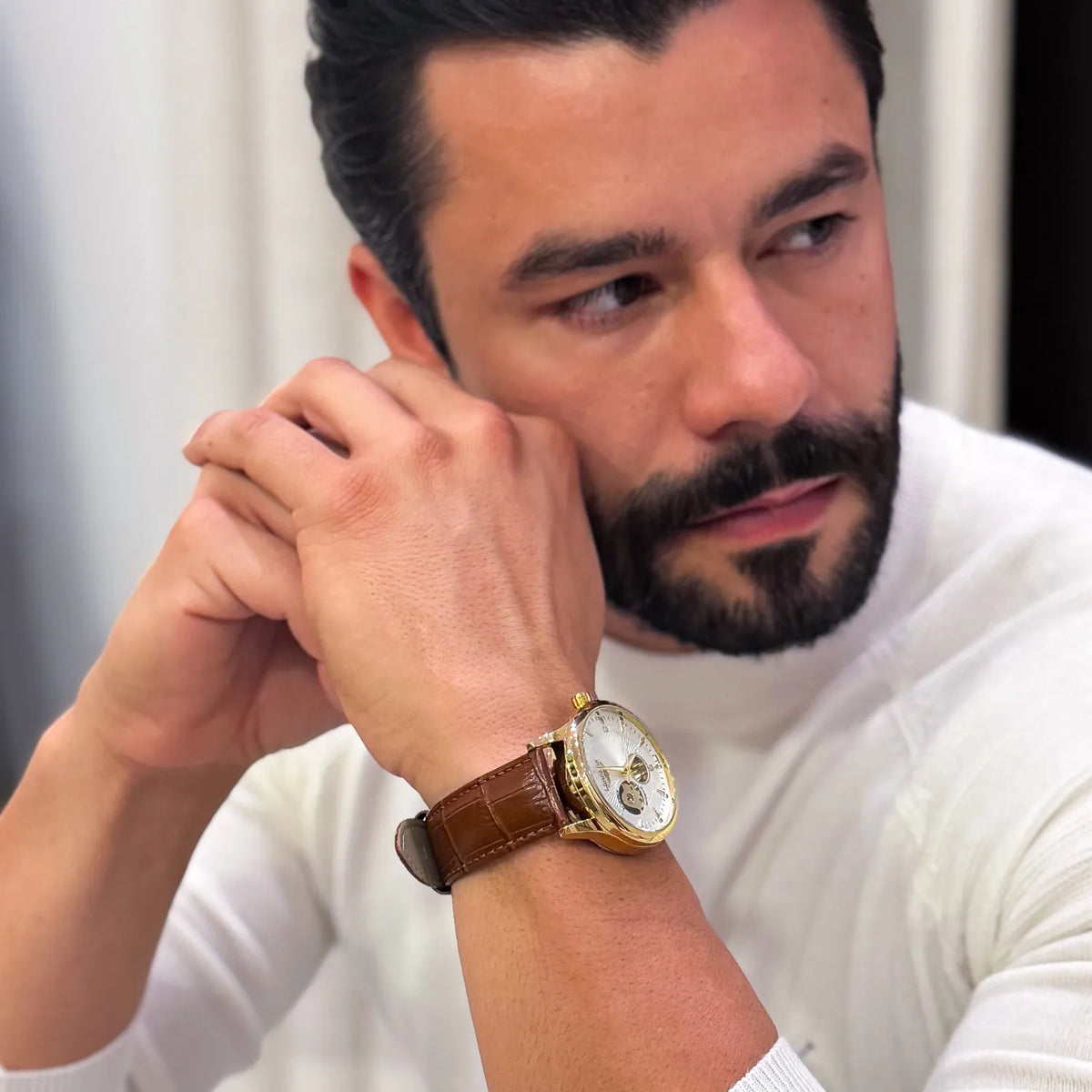 DALMONT Zenith automatic watch worn with a white sweater, hands raised